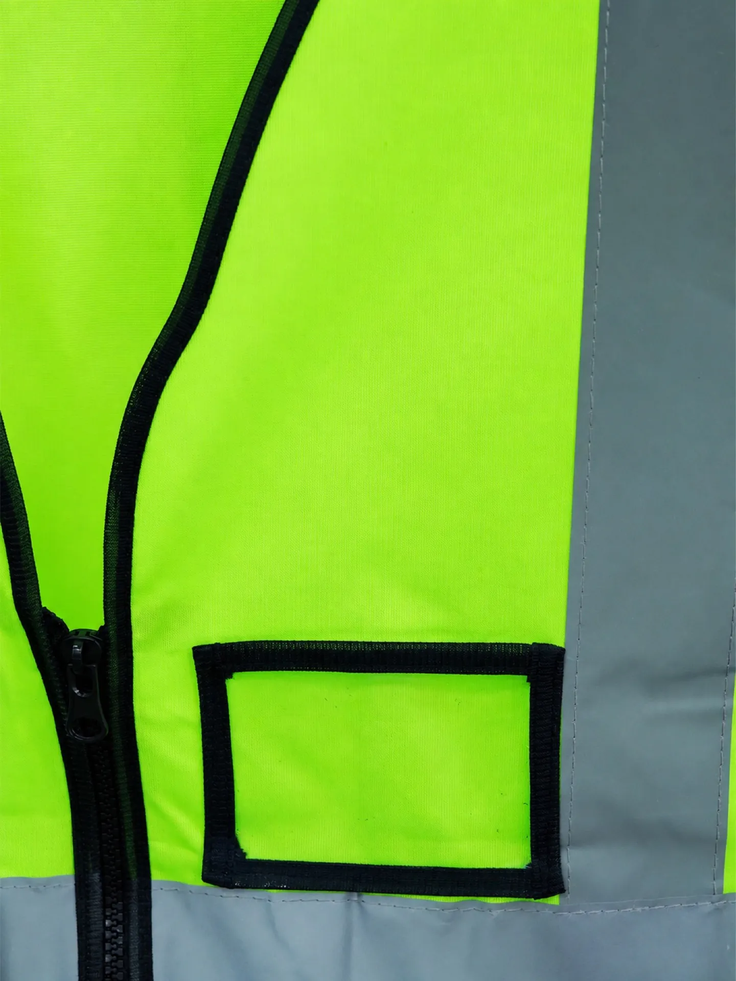 Reflective vest showing tape placement, pockets, binding and closures