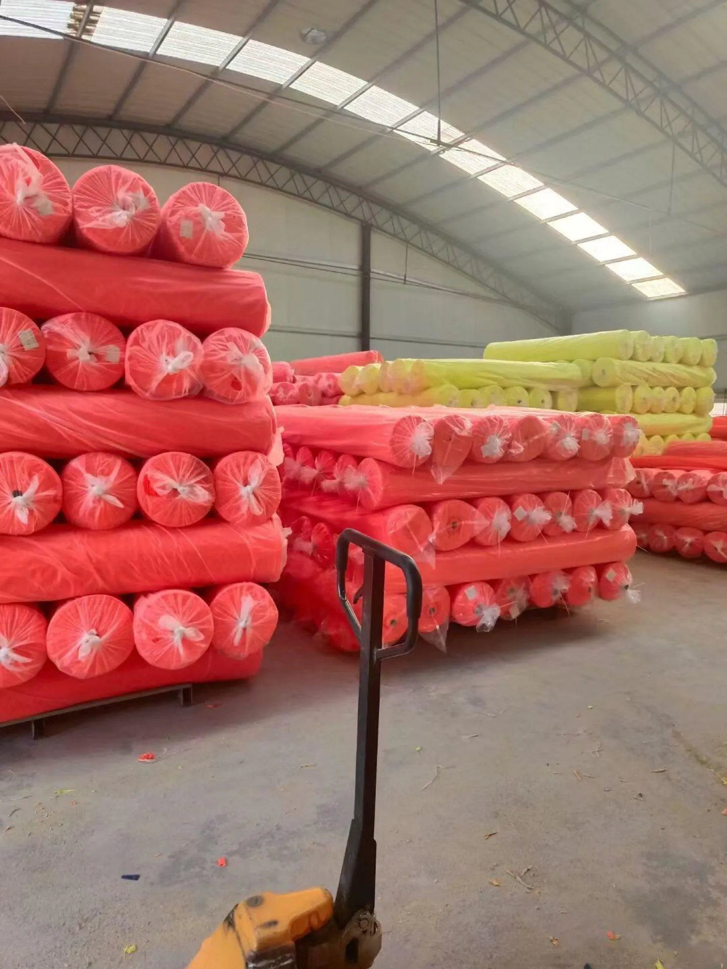 Fluorescent fabric rolls stored before garment production