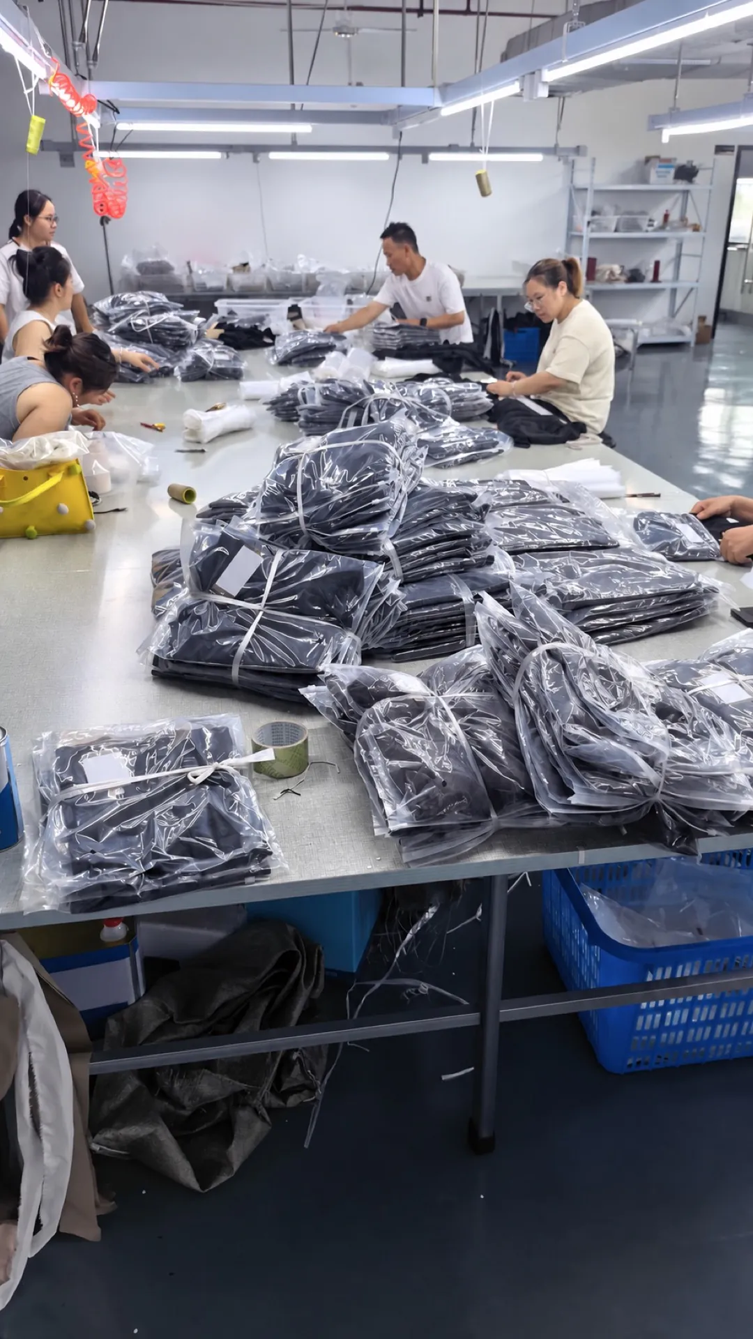 Garment worker preparing packed clothing for order handling